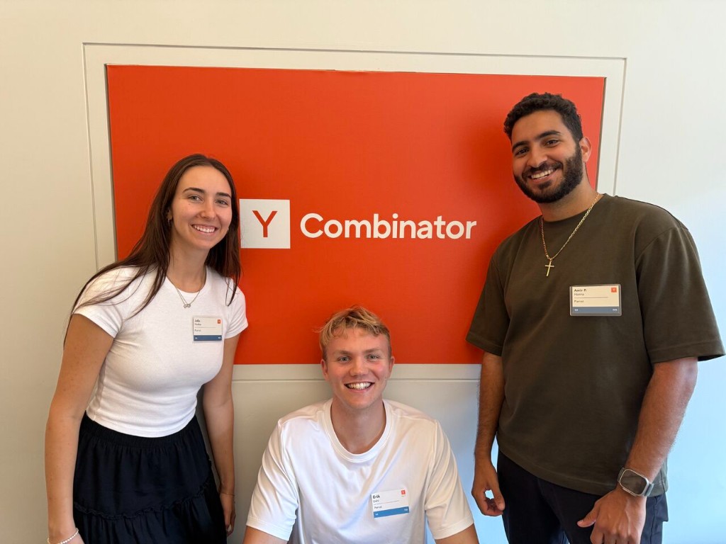Parrot co-founders Julia Hudea, Erik Dahl, and Amir Hanna in front of the Y Combinator sign